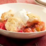 Fresh strawberry rhubarb cobbler with whipped cream